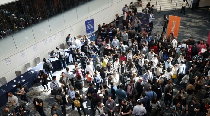 Navigating Academic Conferences for Graduate Students Image of individuals at a cofnerence.